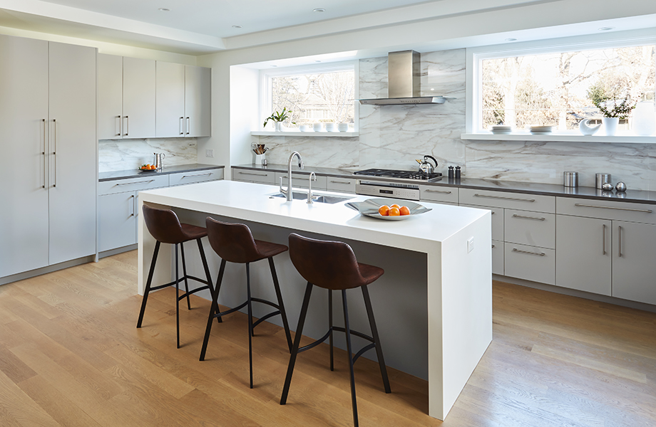 Full kitchen with waterfall island and stools with Grigio Efeso cabinetry and Grigio Antrim feature wall