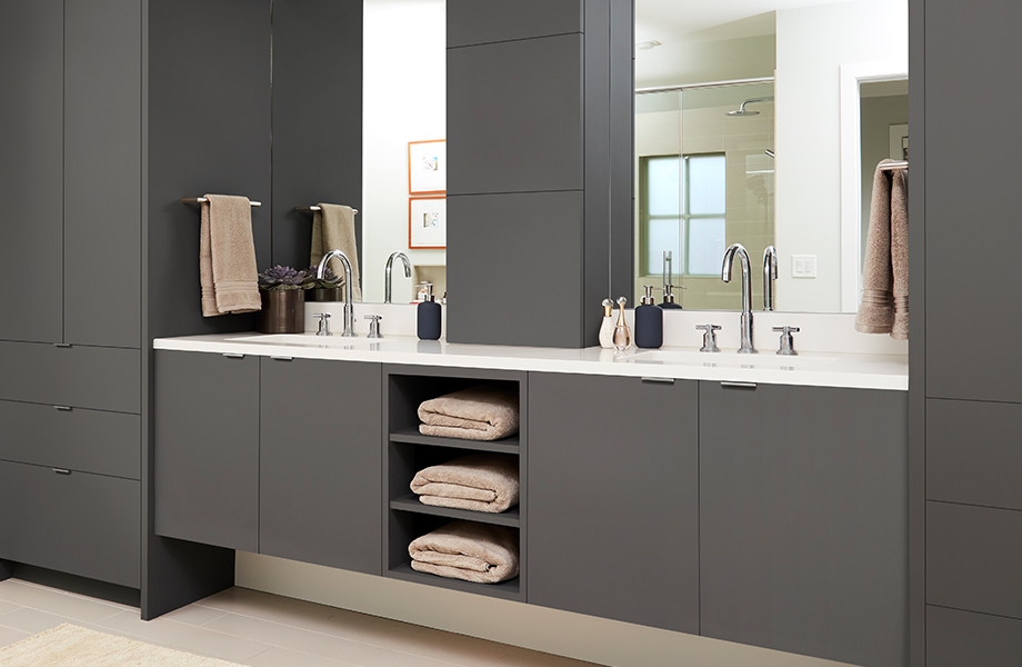 An organized bathroom double vanity with shelves and cabinets