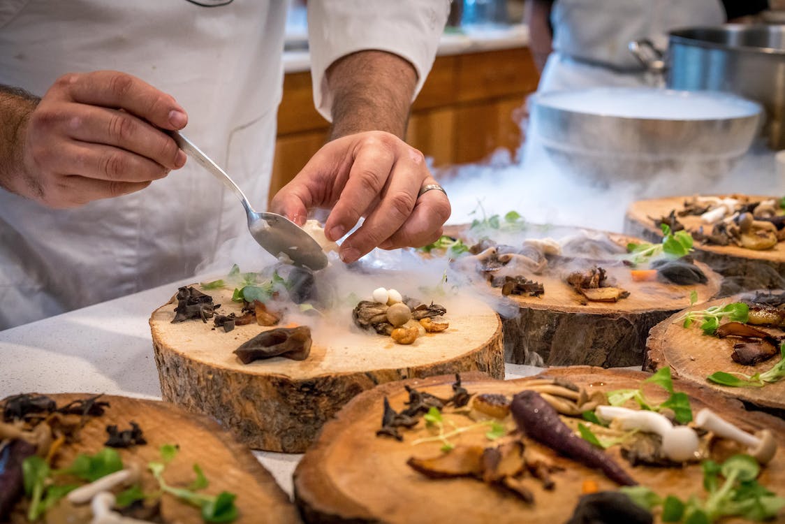 chef plating up food in a commercial kitchen