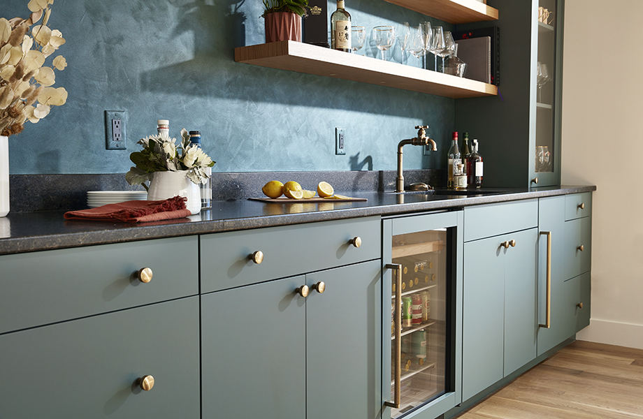 Concept 32 Custom Cabinet Studio with gray FENIX NTM cabinetry, dark countertops, sink, wine glasses and drinks fridge