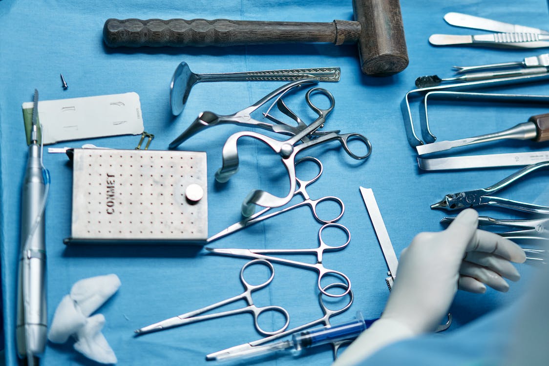 Silver dental tools on a blue table