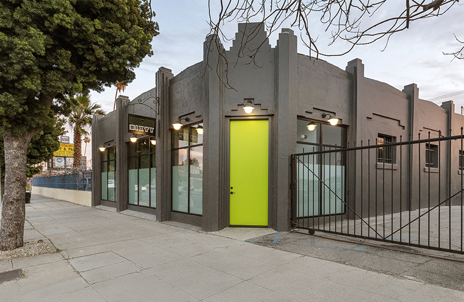 Building with green door and black fence