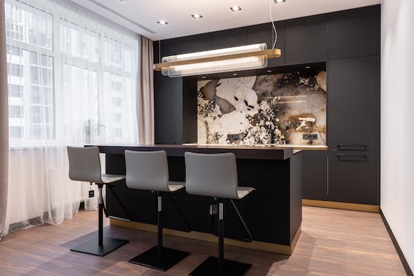 matte black kitchen with a marble backsplash 