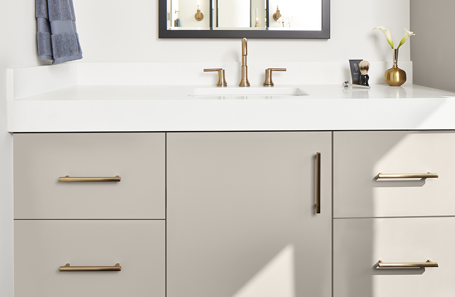 J0748 Beige Arizona super-matte bathroom cabinets with white countertop and gold fixtures