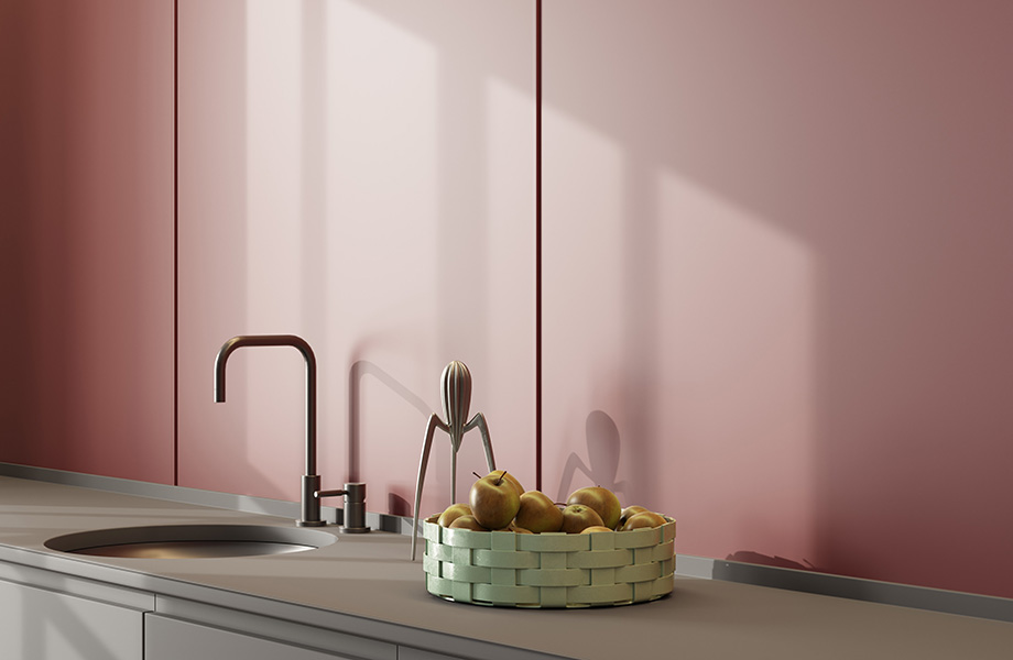A kitchen sink and counter with a rosso jaipur FENIX X-KIN covered wall