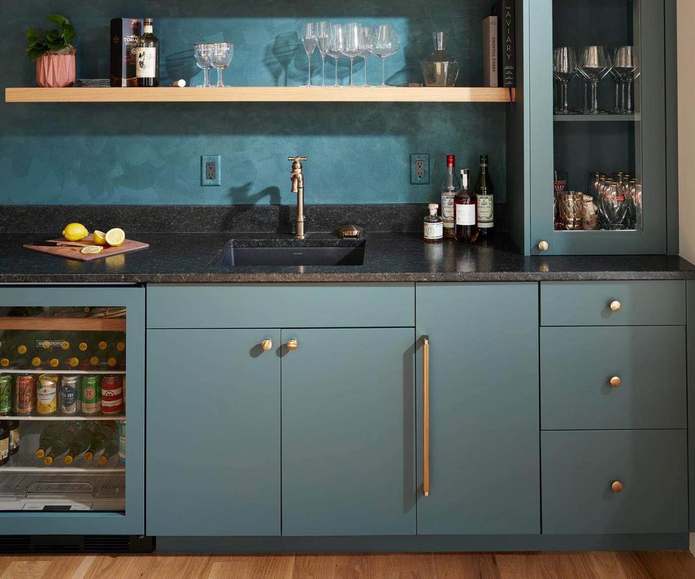Beautiful FENIX NTM Verde Comodoro cabinetry presents a contemporary kitchen aesthetic alongside stunning glass doors and accessories.