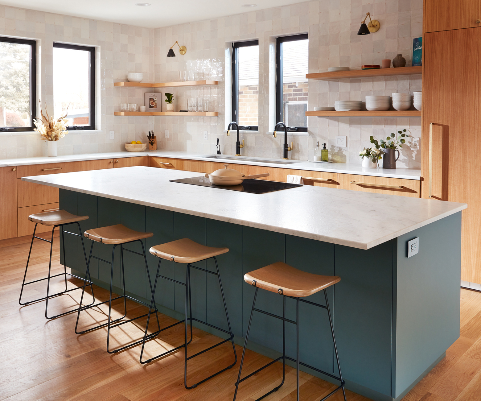 This stunning FENIX NTM Verde Comodoro kitchen island is set in front of a wooden cabinetry backdrop.