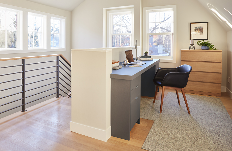 An office setup in a loft with large windows